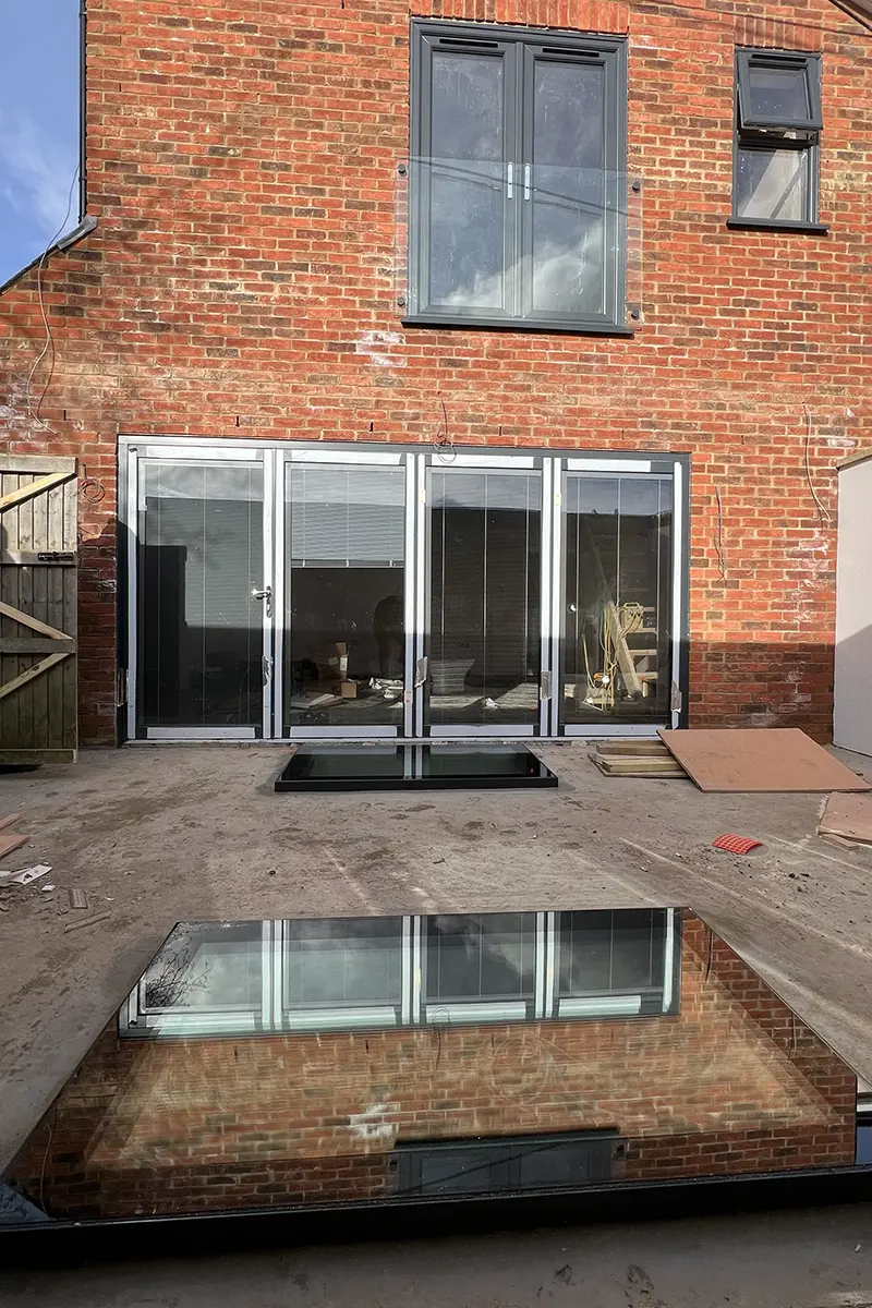 brand new bi fold doors in a garden with roof lights